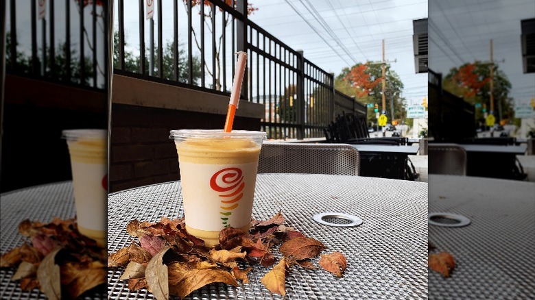 pumpkin smoothie from Jamba Juice is on a table outside