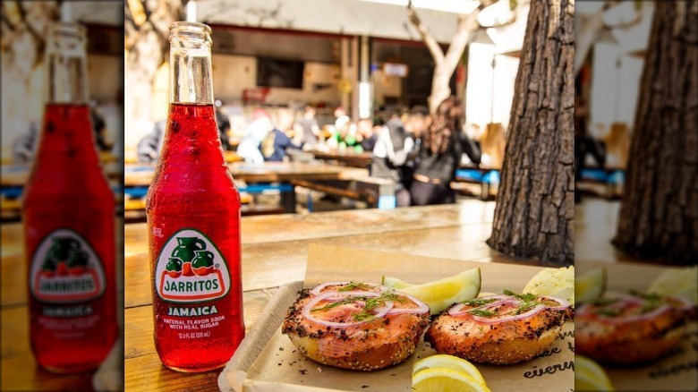 A bottle of jamaica jarritos with food
