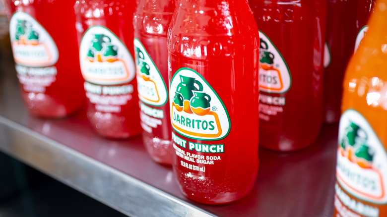 bottles of jarritos fruit punch on a shelf