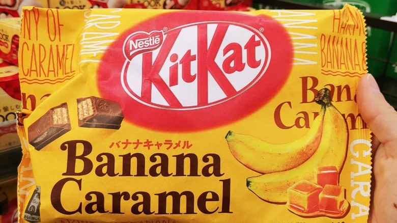 Someone holding package of Banana Caramel flavor Kit Kats