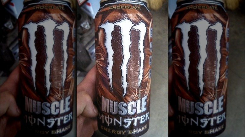 Someone holding can of Chocolate Muscle Monster Energy Shake