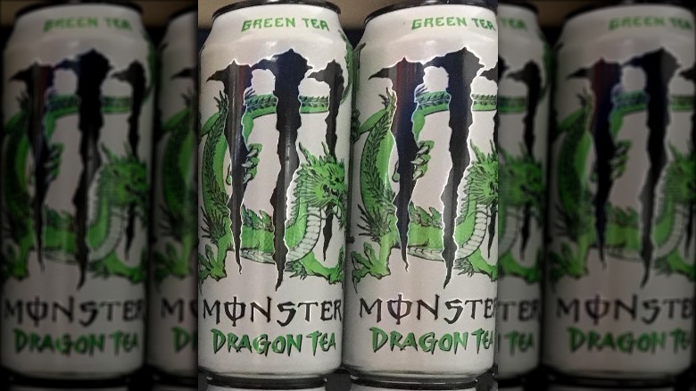 Cans of Green Tea Monster Dragon Iced Tea on store shelf