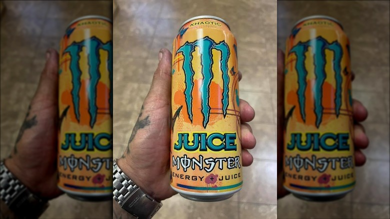 Man holding a can of Khaotic Juice Monster energy drink