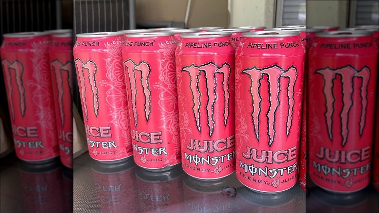 Cans of Pipeline Punch Juice Monster on table