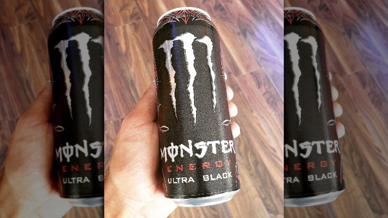 Someone holding a can of Monster Energy's Zero-Sugar Ultra Black