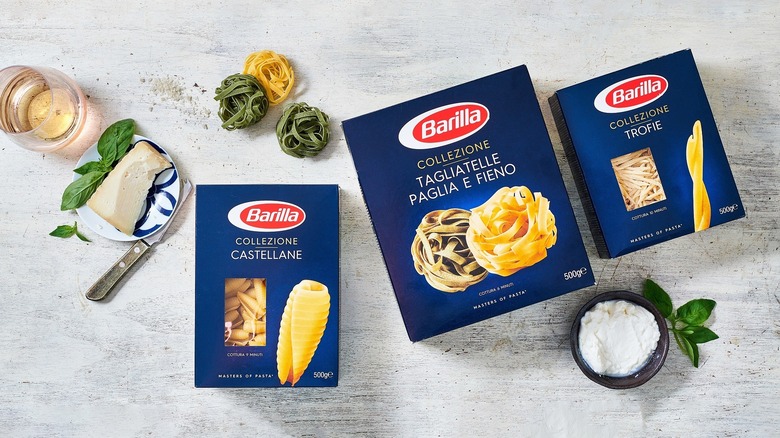 Barilla pasta boxes on counter with salt and cheese