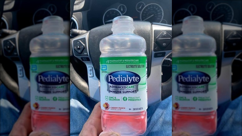 Someone holding bottle of Cherry Punch Pedialyte AdvancedCare