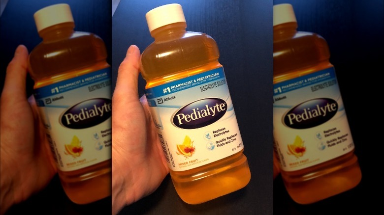 Someone holding bottle of Mixed Fruit Pedialyte Classic