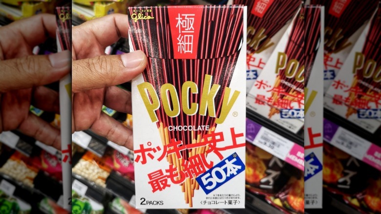 hand holding a box of ultra slim chocolate pocky sticks