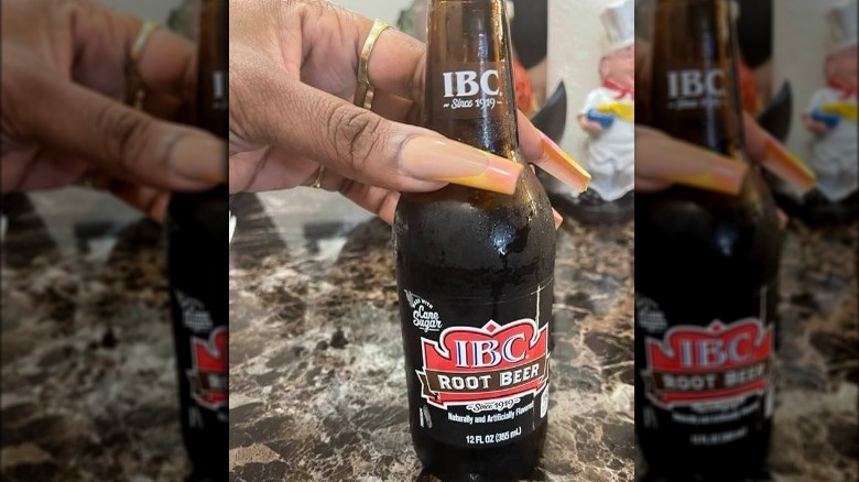 Woman holding bottle of IBC Root Beer