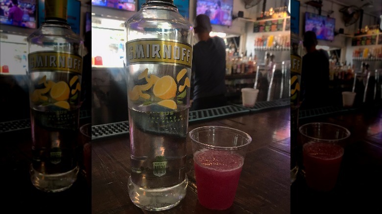 Citrus Smirnoff next to glass at bar