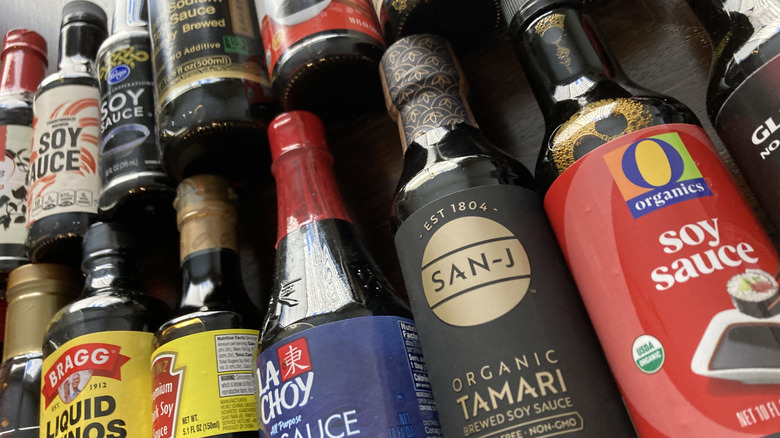 Bottles of soy sauce on a wooden table