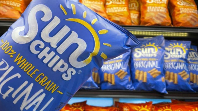 A bag of original sun chips in front a row of sun chips