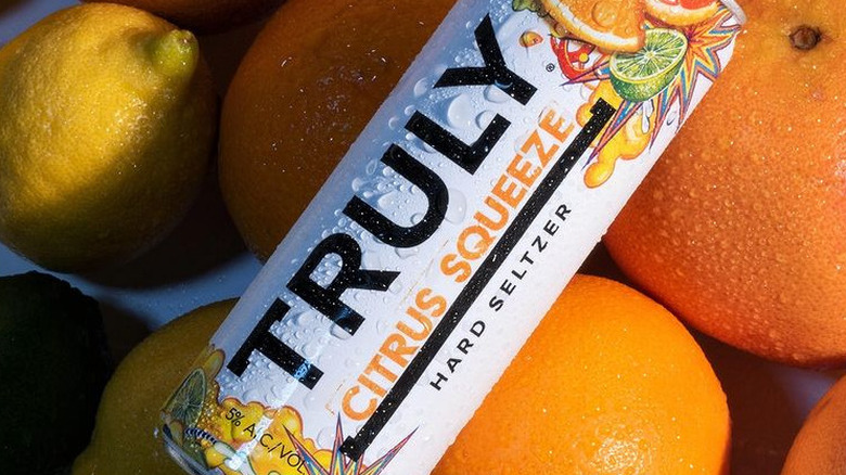 Can of truly citrus squeeze on a bed of citrus