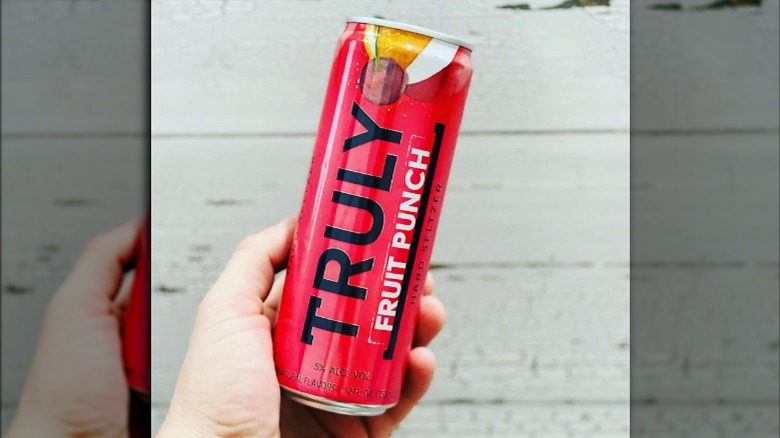 hand holding a can of Truly fruit punch