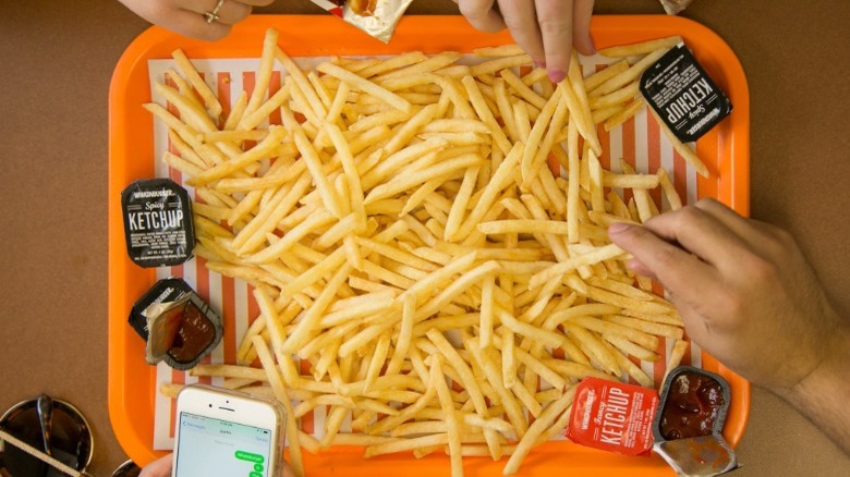 Tray full of Whataburger French Fries with ketchup