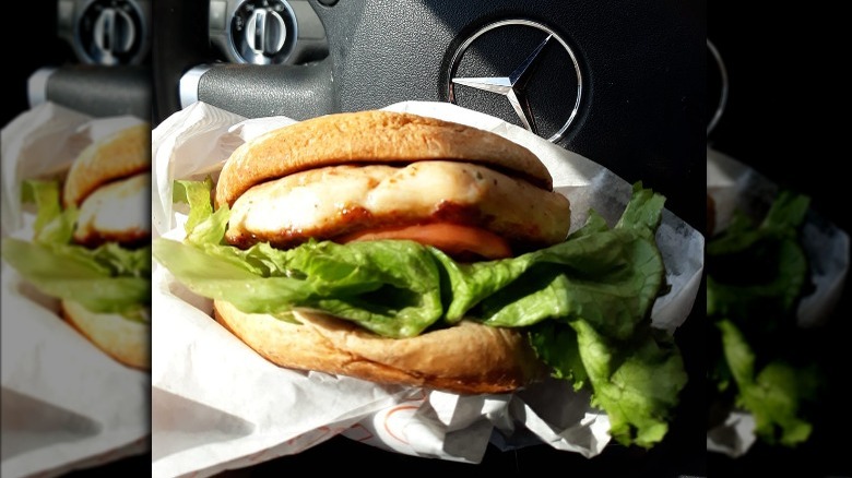 Whataburger Grilled Chicken Sandwich in a car