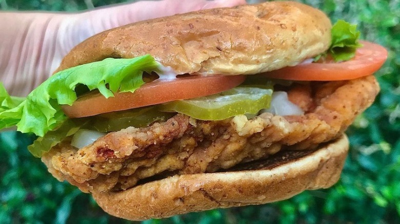 Someone holding a Whataburger Spicy Chicken Sandwich