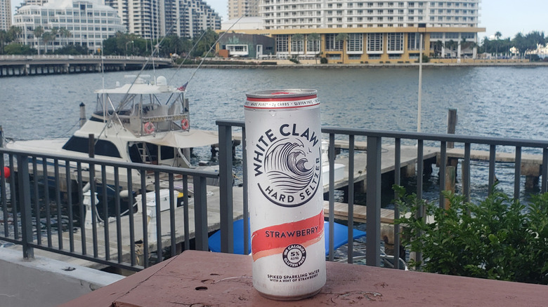 Strawberry White Claw on patio overlooking water