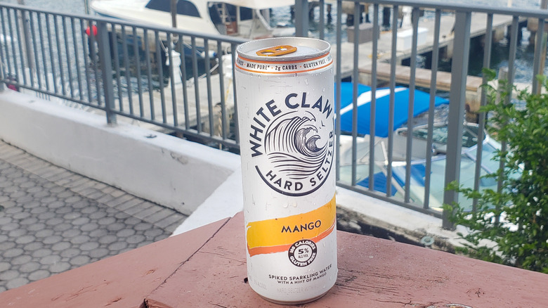 Mango White Claw can on deck of marina