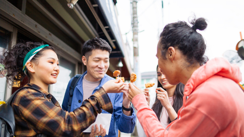 Friends enjoying Filipino street food 