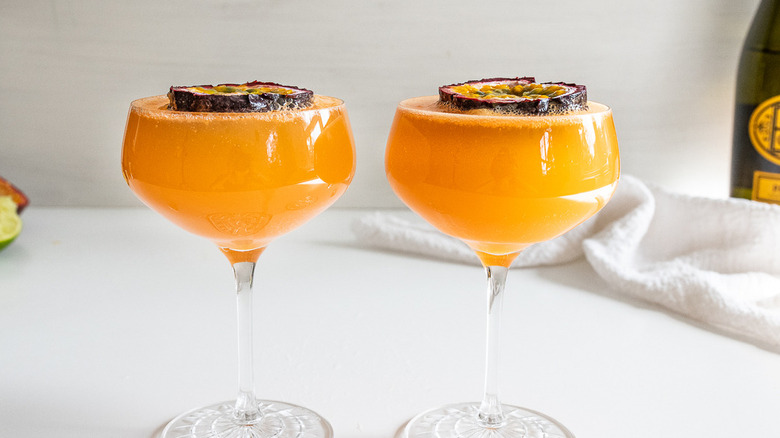 two orange cocktails with passion fruit 