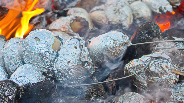 baked potatoes in foil in camp fire