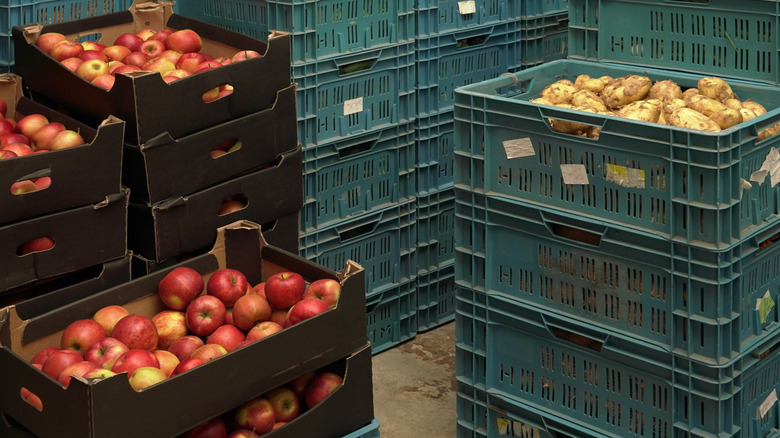 potatoes and apples in crates