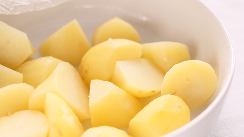 potatoes in bowel with plastic wrap cover