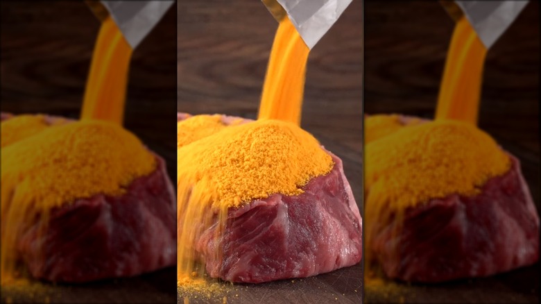 Steak covered in orange cheese powder