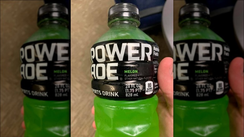 Someone holding bottle of Powerade Melon