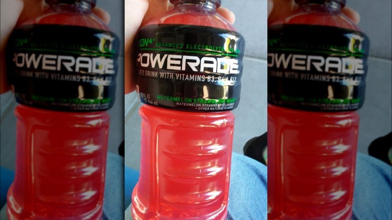 Someone holding Powerade Watermelon Strawberry Wave bottle