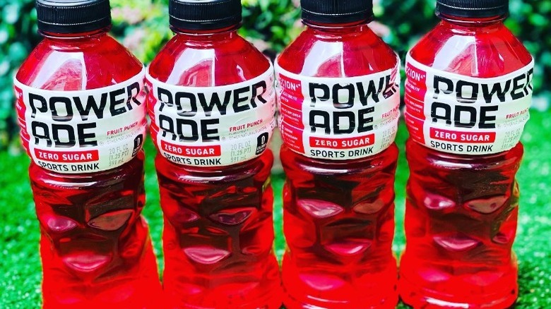 Bottles of Powerade Zero Sugar Fruit Punch on grass