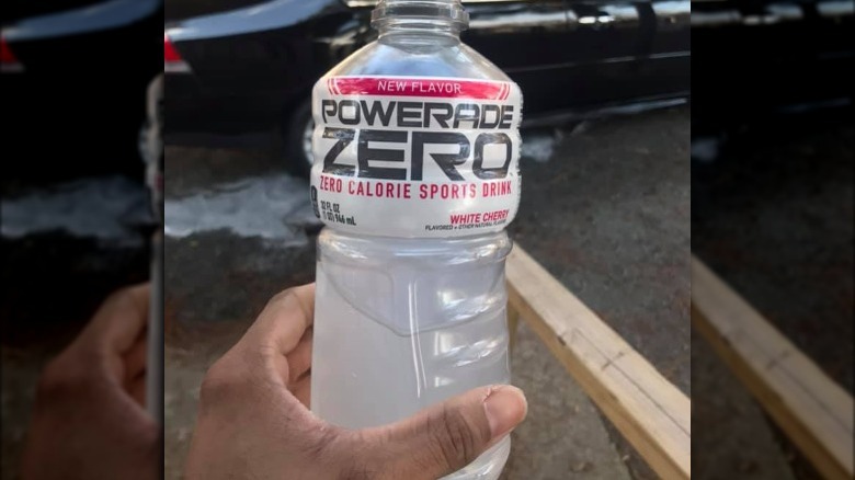 Someone holding bottle of Powerade Zero Sugar White Cherry