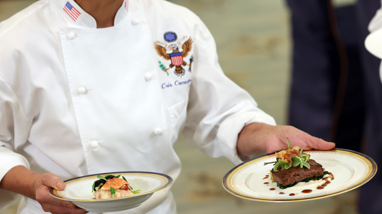 White House chef holding plates