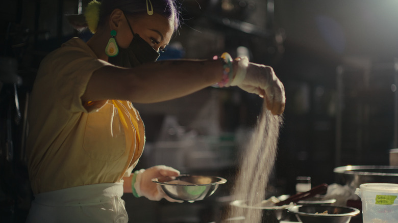 Woman sprinkling flour