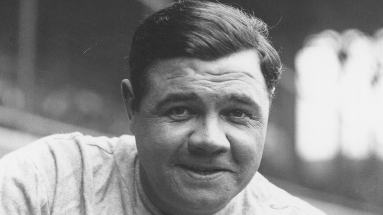 Babe Ruth sitting beside dugout