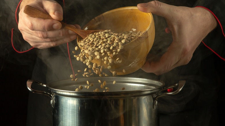 spooning lentils into pan