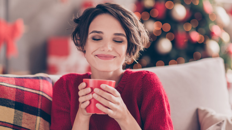 Smiling woman holding mug 