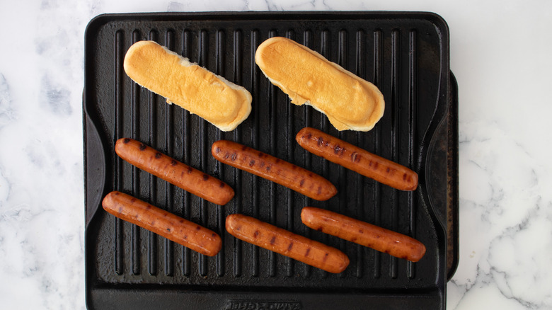 buns and sausages on grill