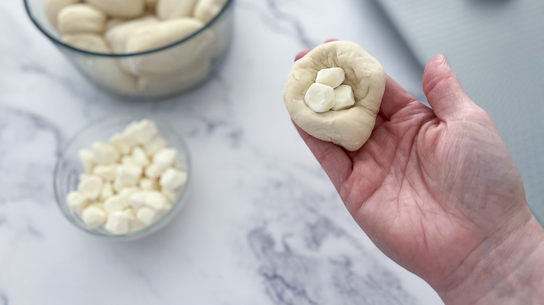 dough with cheese in hand