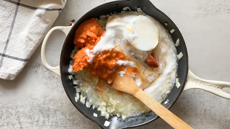 pumpkin curry ingredients in a pan