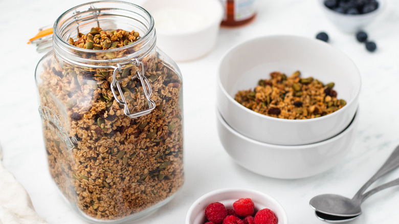 Pumpkin seed granola in storage jar and bowl