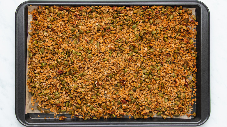 Baked pumpkin seed granola on baking sheet