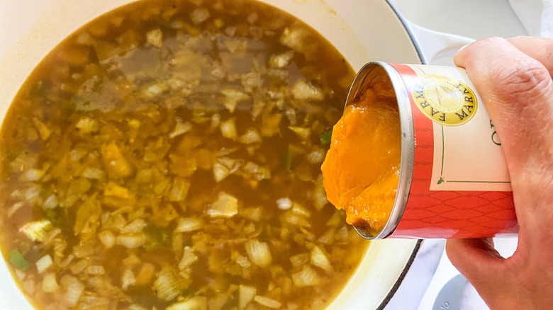 adding canned pumpkin to soup
