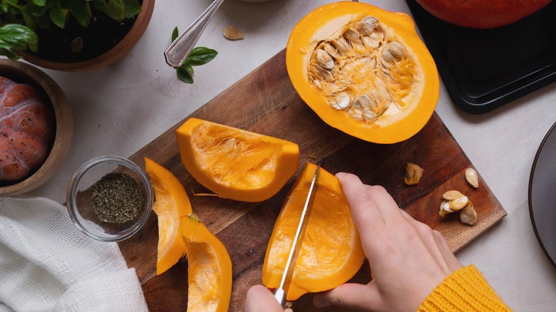 someone slicing pumpkins