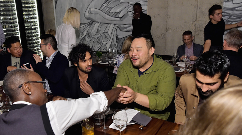 David Chang sitting at a table