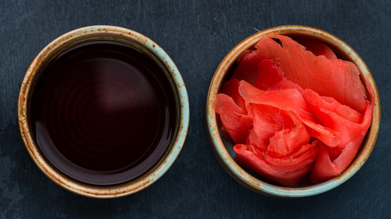 Bowls of soy sauce and ginger on a table