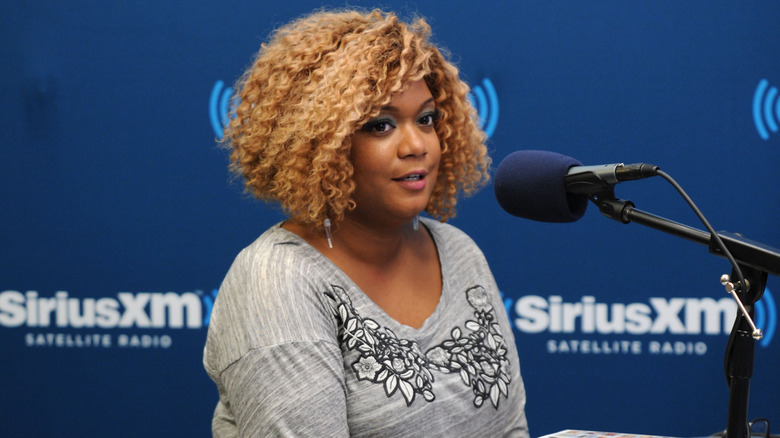 Sunny Anderson at a mic