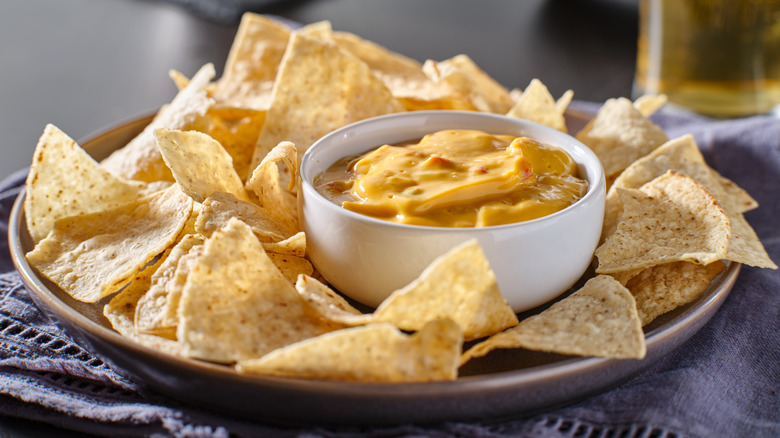 chips and queso on gray plate